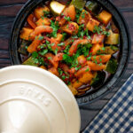Overhead Moroccan influenced vegan vegetable tagine with squash and courgette.