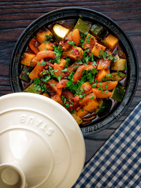 Overhead Moroccan influenced vegan vegetable tagine with squash and courgette.