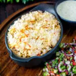 Vegan mushroom biryani served with mint raita and kachumber salad.