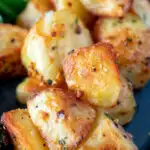 Close up parmentier potatoes with rosemary and garlic featuring a title overlay.