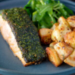 Parmentier potatoes or mini roast potatoes served with herb crusted salmon.