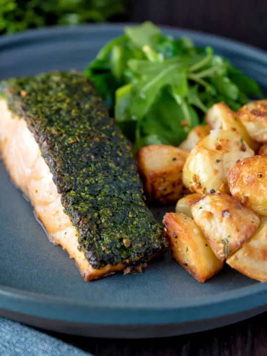 Parmentier potatoes or mini roast potatoes served with herb crusted salmon.