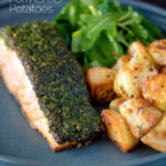 Parmentier potatoes or mini roast potatoes served with herb crusted salmon featuring a title overlay.