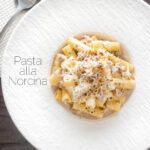 Overhead pasta alla norcina with black pepper and fresh parmesan cheese featuring a title overlay.