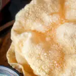 Close up freshly cooked poppadoms or papad served with mint raita.