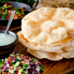 Freshly cooked poppadoms or papad served as part of an Indian spread.