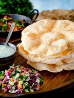 Freshly cooked poppadoms or papad served as part of an Indian spread.