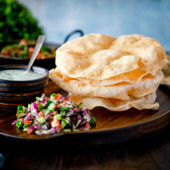 Freshly cooked Indian poppadoms or papad served with kachumber salad and mint raita.