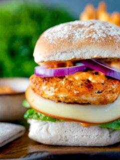 Peri peri chicken burger served with red onion and smoked cheese.