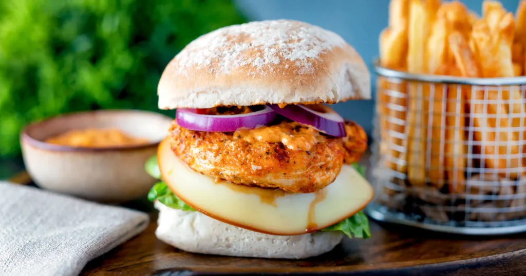 Peri peri chicken burger served with spicy mayonnaise and French fries.