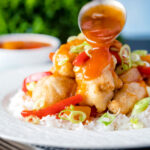 Chinese takeaway style sweet and sour sauce pored over crispy fried chicken balls.