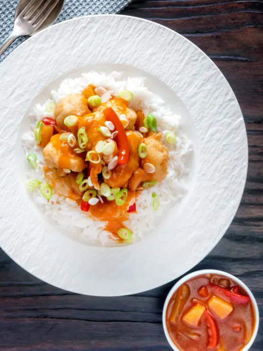 Overhead Chinese takeaway style crispy fried sweet and sour chicken balls.