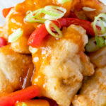 Close up Chinese takeaway style crispy fried sweet and sour chicken balls.