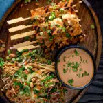 Overhead tofu satay with a peanut sauce and noodle salad featuring a title overlay.