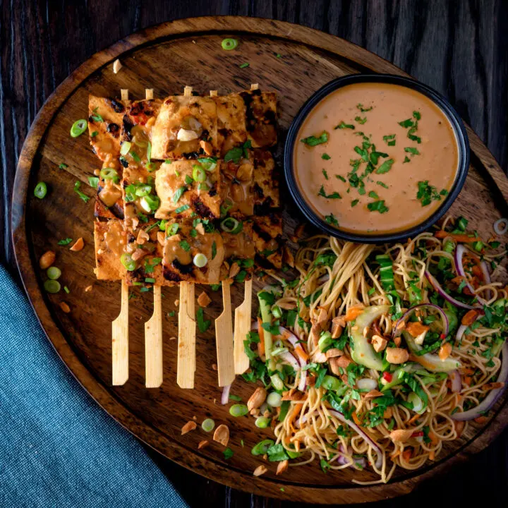 Tofu satay with a peanut dipping sauce, roasted peanuts and noodle salad.