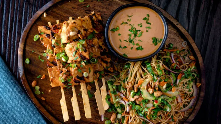 Tofu satay with a peanut dipping sauce, roasted peanuts and noodle salad.