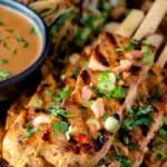 Close up tofu satay with a peanut sauce and noodle salad featuring a title overlay.