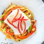 Overhead cod loin cooked en papillote served with sweet chilli noodles featuring a title overlay.