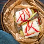 Overhead Cod loin cooked en papillote with Asian flavours.