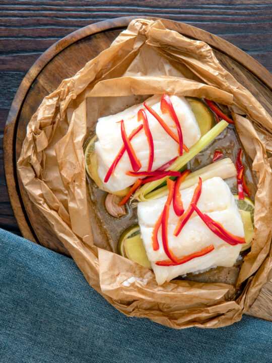 Overhead Cod loin cooked en papillote with Asian flavours.