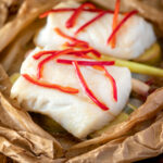 Cod loin cooked en papillote with Asian flavours featuring a title overlay.