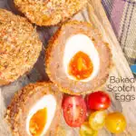 Close up overhead oven baked Scotch eggs with cherry tomatoes featuring a title overlay.