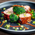 Char siu pork tenderloin, or Chinese BBQ pork served with broccoli and chilli.