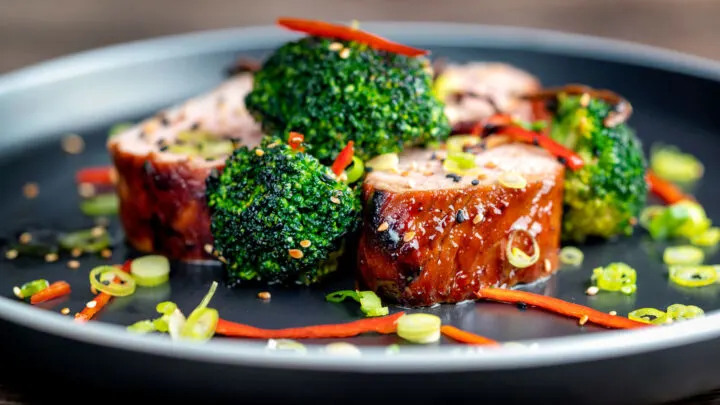 Char siu pork tenderloin, or Chinese BBQ pork served with broccoli and chilli.