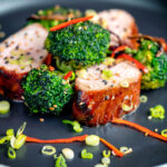 Char siu pork tenderloin, or Chinese BBQ pork served with broccoli stir fry and chilli.