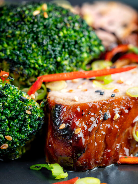 Close up char siu pork tenderloin, or Chinese BBQ pork served with broccoli stir fry.