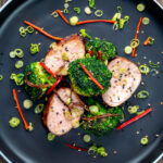 Overhead char siu pork tenderloin, or Chinese BBQ pork served with broccoli stir fry.