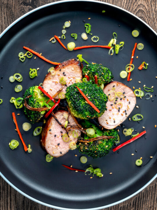 Overhead char siu pork tenderloin, or Chinese BBQ pork served with broccoli stir fry.