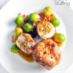Overhead sage and onion stuffed chicken ballotine served with gravy, Yorkshire pudding & sprouts featuring a title overlay.