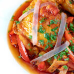 Close up chicken Basque with peppers and tomatoes.