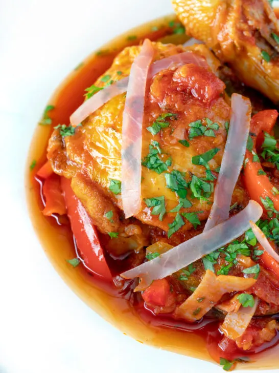 Close up chicken Basque with peppers and tomatoes.
