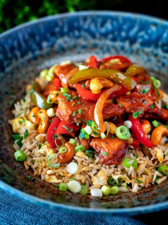 Dragon chicken with peppers and cashew nuts served with egg fried rice.