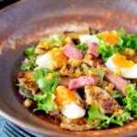 Gammon salad with seared pineapple, boiled eggs and potatoes.