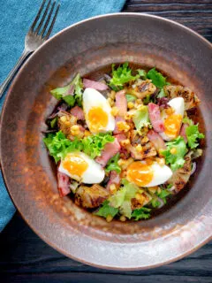 Overhead gammon salad with seared pineapple, boiled eggs and potatoes.
