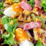 Close up gammon salad with seared pineapple, boiled eggs and potatoes.