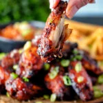 Close up Korean chicken wings showing the meat inside a cooked wing.