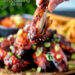 Close up Korean chicken wings showing the meat inside a cooked wing featuring a title overlay.