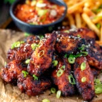 Korean influenced chicken wings served with French fries and kimchi.