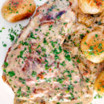 Overhead thick cut Normandy pork chops in a creamy cider sauce with potatoes featuring a title overlay.