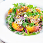 Peach and feta cheese salad with puy lentils and rocket or arugula.