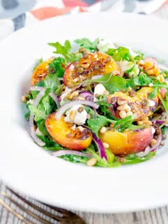 Peach and feta cheese salad with puy lentils and rocket or arugula.