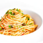 Tomato tuna pasta with capers and fresh parsley.