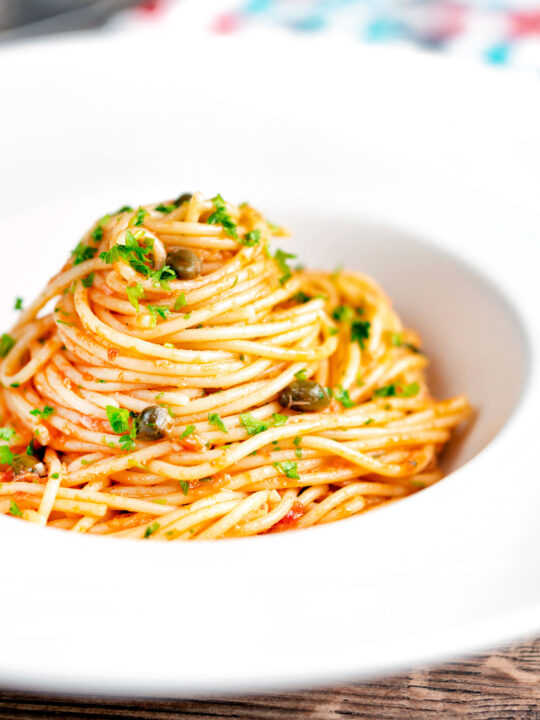 Tomato tuna pasta with capers and fresh parsley.