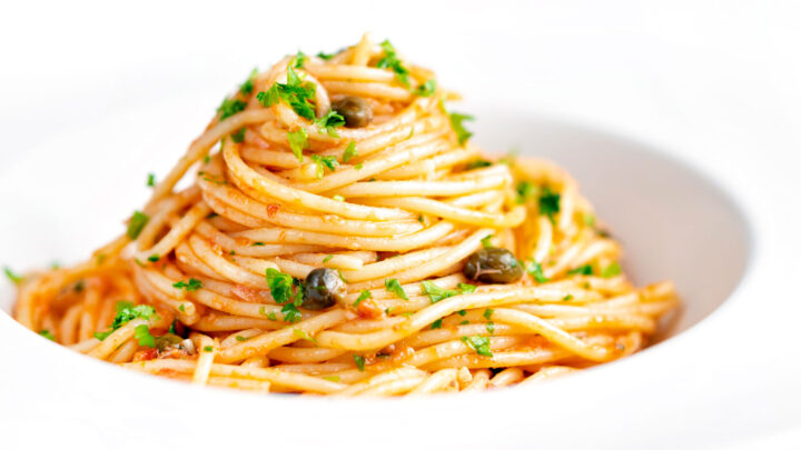 Quick and easy tomato tuna pasta with capers and fresh parsley.