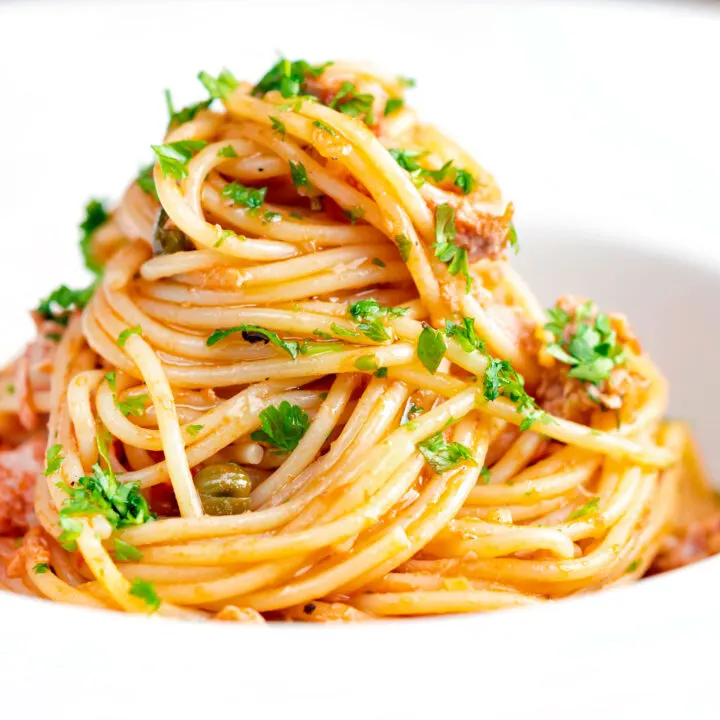 Quick and easy tomato tuna pasta with capers and fresh parsley.