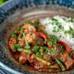 Indian inspired beef sausage curry served with rice featuring a title overlay.